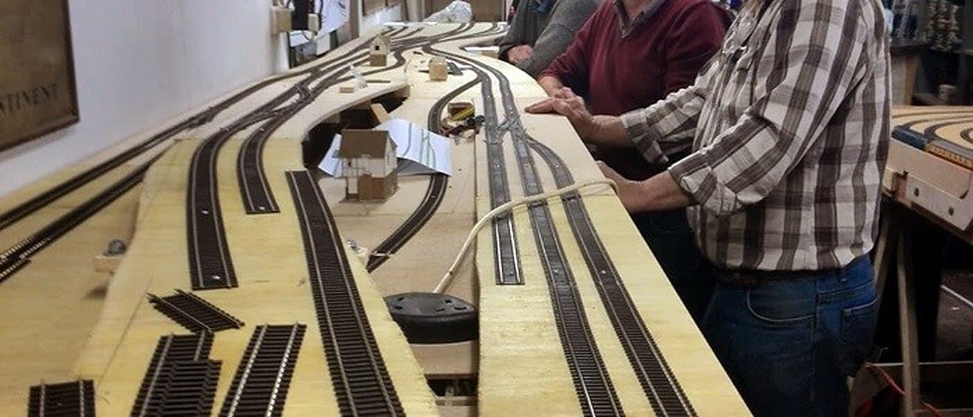 Members laying track on the club OO layout under construction